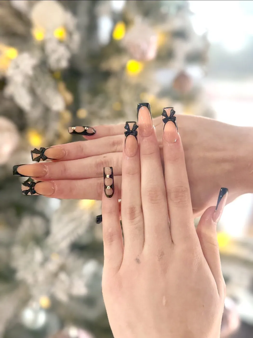 Black bow nail art created at Cozy Nail and Head Spa Cypress